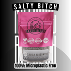 A pink stand-up pouch labeled 'SALTY BITCH' with a clear lower section showing smoked alderwood Sea salt. The package has black text and icons including 'Be & Bit Salty,' 'Made in USA,' and 'Organic.