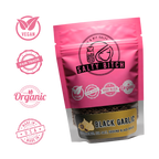 Pink package of 'Salty Bitch' black garlic with certification logos on a white background
